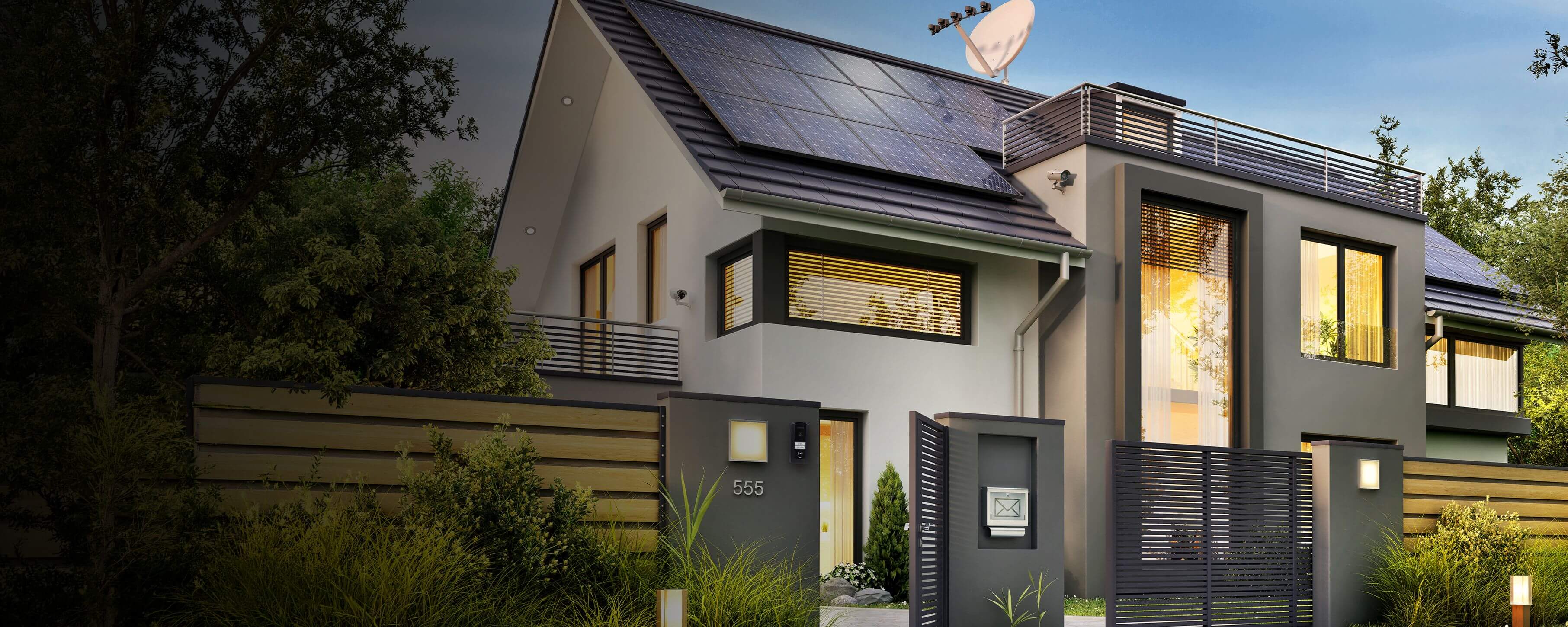 Modern detached house with solar panels, a gated entrance, and a wall-mounted video intercom at the front gate.