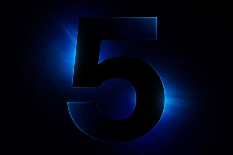 Large black number 5 glowing with blue light on a dark background.